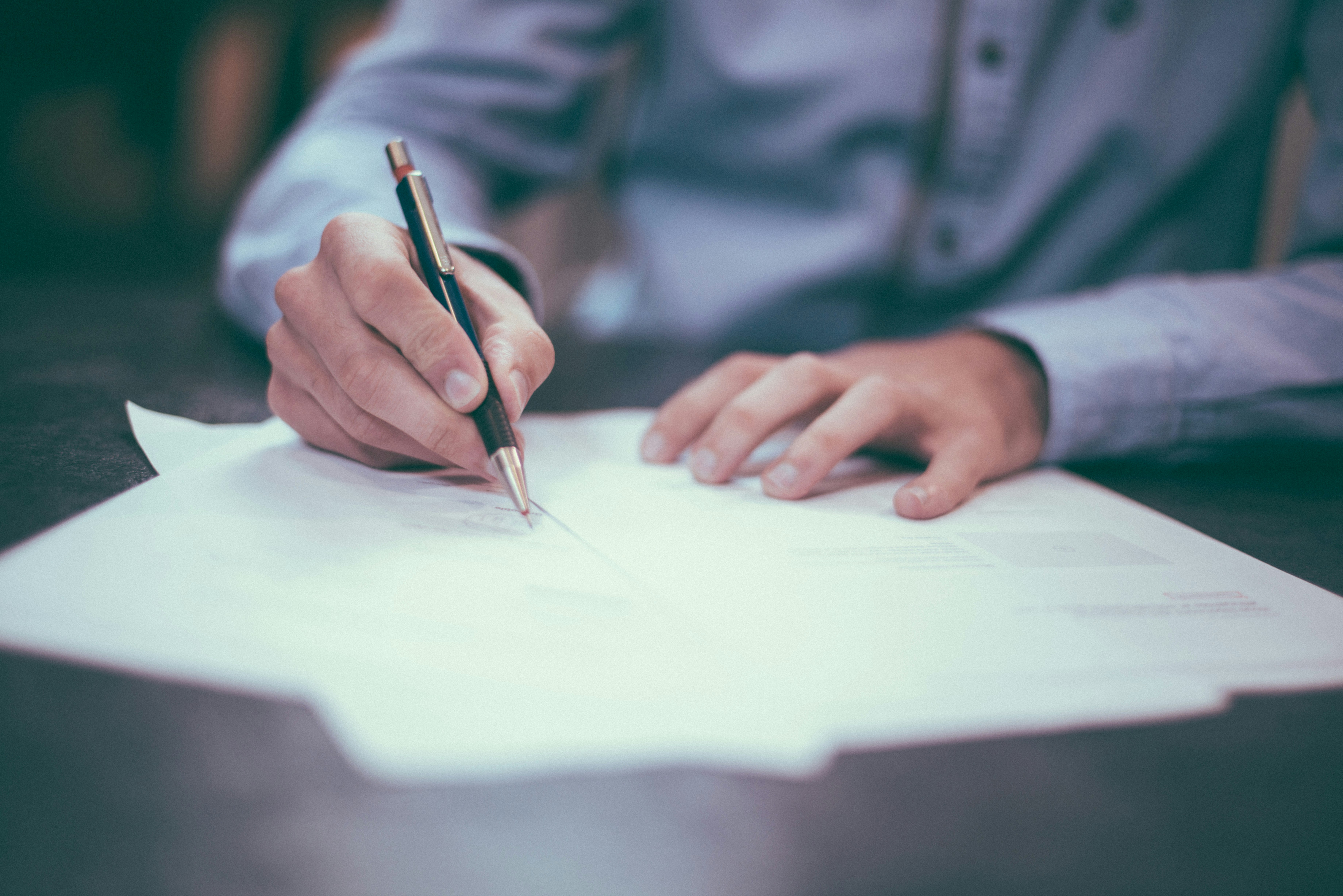 Hands reviewing a commercial agreement at a desk